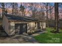 Inviting home with a quaint porch, garage, well-kept lawn, and a peaceful, tree-lined setting at 8432 Othello Pl, Charlotte, NC 28227