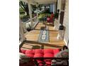 Inviting porch with red cushions, a stylish rug, potted plants, and charming decor, offering a relaxing outdoor space at 1001 N Cannon Blvd, Kannapolis, NC 28083