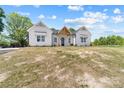 Charming white farmhouse featuring a welcoming front porch and black front door with a well-manicured lawn at 1037 Dameron Rd, Bessemer City, NC 28016
