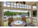 Charming balcony view overlooking the lake with a stone table and chairs, creating a serene outdoor living space at 107 Pier 33 Dr # 103, Mooresville, NC 28117