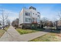 Modern townhome boasts a striking architectural design with a combination of white siding and brick accents at 107 W Poindexter Dr, Charlotte, NC 28203