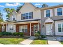 Two-story townhome showcasing a classic design with brick accents and well-kept landscaping at 110 Rhett Ct, Fort Mill, SC 29715