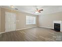 Bright living room with modern floors, ceiling fan, and a cozy fireplace at 110 Rhett Ct, Fort Mill, SC 29715