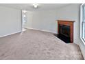 Spacious living room featuring a fireplace with classic wooden mantle at 1121 Swearngan Ridge Ct, Charlotte, NC 28216