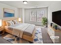 Bright main bedroom with light wood furniture, a large bed, and a cool accent rug at 1121 Swearngan Ridge Ct, Charlotte, NC 28216