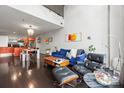 Open-concept living area featuring hardwood floors, modern furnishings, high ceilings, and an attached kitchen at 1133 Metropolitan Ave # 318, Charlotte, NC 28204