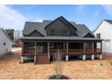 Expansive back porch offering ample space for outdoor living and entertaining with beautiful wooden supports at 123 Mills Garden Rd, Statesville, NC 28625