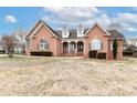 Charming brick home featuring a covered porch, dormer windows, and a well-manicured lawn at 123 Wheatridge Dr, Statesville, NC 28625