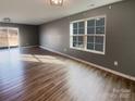 Bright living room featuring hardwood floors, a large window, and neutral wall colors at 1298 Bryson Ln, Denver, NC 28037