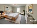 Comfortable main bedroom with a queen bed, neutral colors, and stylish decor, virtually staged at 1298 Bryson Ln, Denver, NC 28037