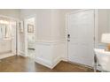 Inviting entryway with hardwood floors, white trim, and a view into the adjoining rooms with neutral walls at 14707 Batteliere Dr, Charlotte, NC 28278