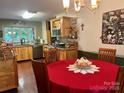 Cozy kitchen and dining area, featuring light wood cabinets, stainless steel appliances and hardwood floors at 1496 Givens St, Hickory, NC 28602