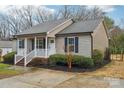 Charming single-story home with a cozy front porch and well-maintained landscaping at 2421 Winfield St, Kannapolis, NC 28083