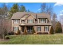 Beautiful two-story home with stone accents, inviting front porch, and lush green lawn at 3019 Foggy Hollow Ln, Clover, SC 29710
