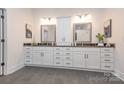 Elegant bathroom featuring dual sinks, dark countertops, white cabinetry, and gray tiled floor at 407 Newstyle Way # 2, Cramerton, NC 28056