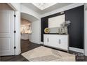 A bright entryway featuring a decorative cabinet and doorway leading to a kitchen area at 407 Newstyle Way # 2, Cramerton, NC 28056