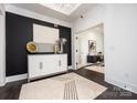 Bright entryway featuring a decorative cabinet against a bold accent wall and doorway leading to an office at 407 Newstyle Way # 2, Cramerton, NC 28056