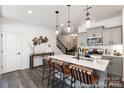Modern kitchen boasts stylish pendant lighting, quartz countertops, and stainless steel appliances at 4170 Claret Cup Dr # 39, Kannapolis, NC 28083
