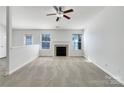 Bright living room featuring a fireplace, large windows, and neutral decor at 4427 Wills Way, Charlotte, NC 28227