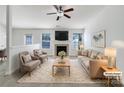 Bright living room featuring a fireplace, large windows, and neutral decor, virtually staged at 4427 Wills Way, Charlotte, NC 28227