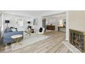 Spacious living room with fireplace, plush rug, and views of kitchen and dining areas at 4913 Seacroft Rd, Charlotte, NC 28210