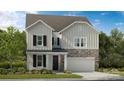 Charming two-story home with stone accents, a covered porch, and well-maintained landscaping at 5009 Duval Cir, Tega Cay, SC 29708