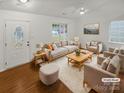 Bright living room with ample seating, a ceiling fan and natural light from the front windows at 5134 Possum Trot Ln, Charlotte, NC 28215