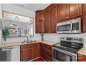 A modern kitchen features stainless steel appliances, a view to the dining area, and ample counter space at 515 Blue Crush Ct, Rock Hill, SC 29732