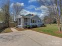 Single-story home with a welcoming screened-in porch and a driveway, perfect for easy parking at 5300 Buckingham Dr, Charlotte, NC 28209