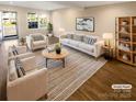 Bright, virtually staged living room with modern furniture, a large rug, and ample natural light at 6436 Old Pineville Rd # C, Charlotte, NC 28217
