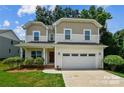 Charming two-story home featuring a spacious front yard, a two-car garage, and a welcoming front porch at 734 Rocky Grove Gln, York, SC 29745