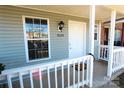 Inviting front porch with white railing, offering a cozy entrance to the home at 8224 Golf Ridge Dr, Charlotte, NC 28277