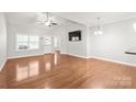 Spacious living room features hardwood floors, high ceilings, and abundant natural light from large windows at 8513 Loxton Cir, Charlotte, NC 28214