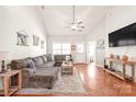 Inviting living room featuring a vaulted ceiling, hardwood floors, and comfortable seating at 8513 Loxton Cir, Charlotte, NC 28214