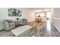 Spacious living area with wood floors, neutral paint, and a view of the dining area at 8929 Bryant Field Cir, Charlotte, NC 28277