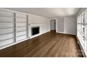 Spacious living room with fireplace, hardwood floors, built-in shelves, and an open layout at 924 Springdale Ln, Gastonia, NC 28052