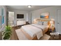 Staged primary bedroom featuring a king bed, ensuite bathroom, closet, and modern decor at 924 Springdale Ln, Gastonia, NC 28052