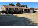 Picture of a charming single-story brick home with a well-manicured lawn and mature landscaping on a sunny day at 95 Icard Ridge Road Ext, Granite Falls, NC 28630