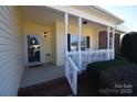 Welcoming front porch with white railing, offering a cozy seating area and charming entrance at 1013 Mays Ct, Gastonia, NC 28054