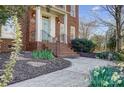 Close-up of a brick staircase leading up to a light-blue front door with well-maintained landscaping at 10207 Rattersly Ct, Charlotte, NC 28277