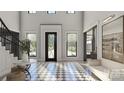 Bright foyer featuring checkerboard tile, staircase with black iron railing, and an abundance of natural light at 1025 Maxwell Ct # 7, Marvin, NC 28173