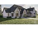 Gorgeous stone and dark trim accentuates this spacious single Gathering home with well manicured landscaping and a lush lawn at 1057 Maxwell Ct # 13, Marvin, NC 28173