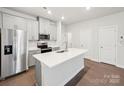 Kitchen with stainless steel appliances, white cabinets, and center island at 114 Ciara Pl # A, Mooresville, NC 28117