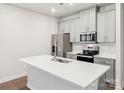 Modern kitchen featuring stainless steel appliances and a large island with a sink at 114 Ciara Pl # A, Mooresville, NC 28117