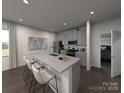 Modern kitchen with stainless steel appliances, a central island with bar stools and gray cabinetry at 114 Ciara Pl # C, Mooresville, NC 28117