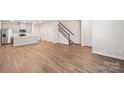 Open floor plan offers wood-look flooring and blends the living room with the kitchen in this contemporary space at 114 Ciara Pl # C, Mooresville, NC 28117