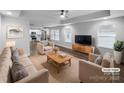 Staged living room showcasing the open floor plan with hardwood floors and tray ceiling at 118 W Lee Ave, Bessemer City, NC 28016