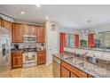 Well-equipped kitchen with stainless steel appliances, granite countertops, and wooden cabinets at 121 Inlet Point Dr, Tega Cay, SC 29708