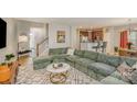 Comfortable living room with a sectional sofa, stylish rug, and open layout to kitchen at 121 Inlet Point Dr, Tega Cay, SC 29708