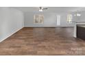 Spacious living room with hardwood floors, a ceiling fan, and natural light at 121 Woodbridge Cir, Mount Holly, NC 28120
